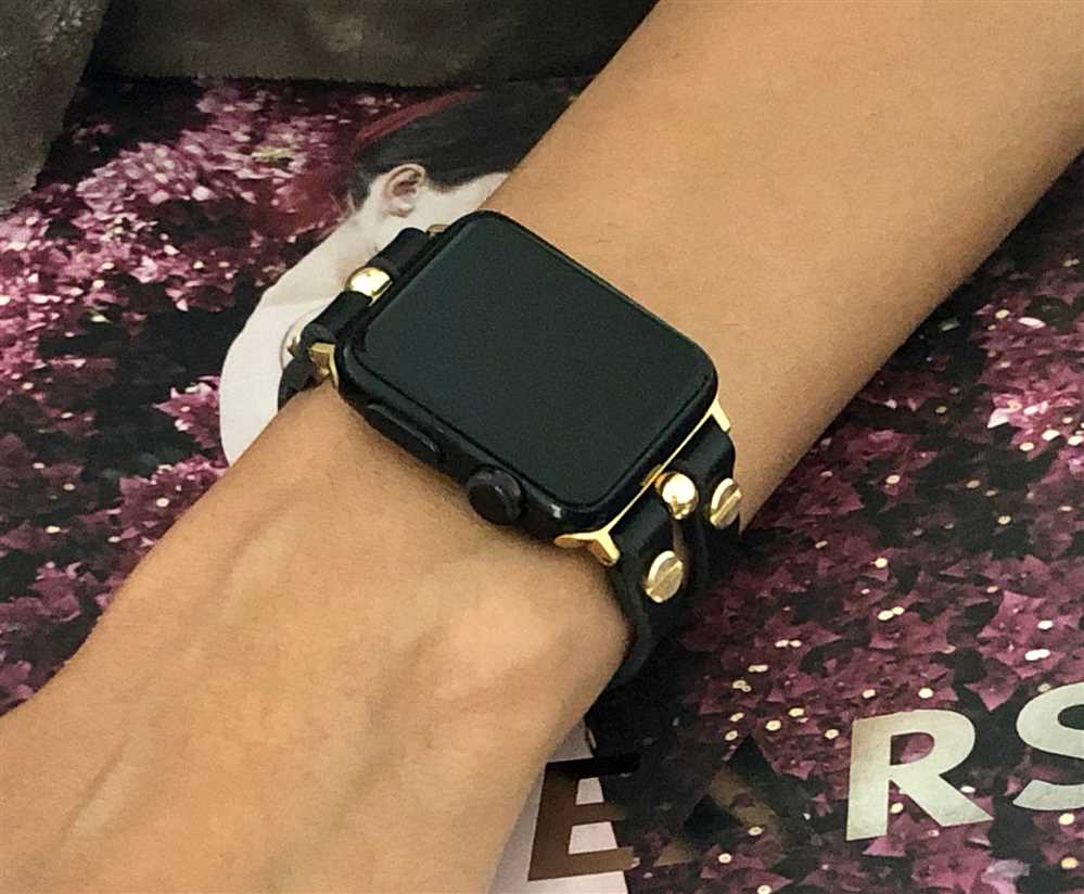 Black apple watch with gold band